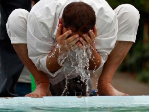 A Muslim man performs ablution from the water of a fountain before performing prayers inside Kashmir’s ancient Jamia Masjid during the holy month of Ramadan, in Srinagar, on August 3, 2012.